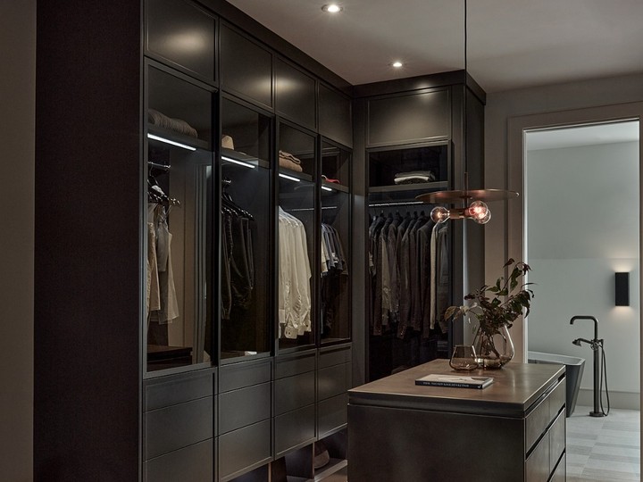  “Moody, like a cigar room” was designer Kristi Bullock’s goal for the closet in the principal bedroom that’s open to the bedroom and bathroom.