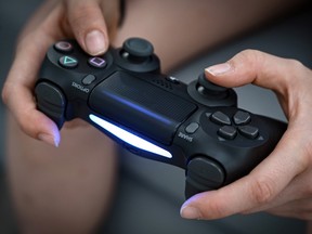 Detail of the gamepad of a person playing video games during a free summer Esport course for youth in Boulogne-Billancourt on July 22, 2020.