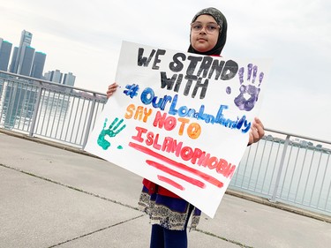 A participant in a June 6, 2022, march for the Afzaal family.
