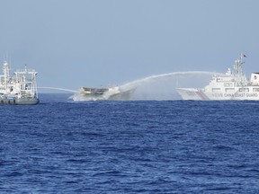A Philippine resupply vessel is hit by two Chinese coast guard water canons as they tried to enter the Second Thomas Shoal in the disputed South China Sea on Tuesday.