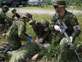 Canadian reserve soldiers participate in a simulated causality scenario.