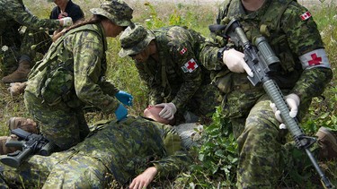 Canadian reserve soldiers participate in a simulated causality scenario.