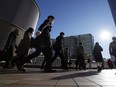 Commuters walk in a passageway during a rush hour at Shinagawa Station