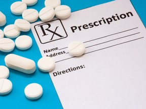 Tablets of medication on top of a prescription form.
