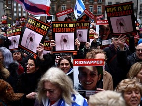 Protesters hold placards and wave Israeli flags as they take part in a demonstration "Rape is NOT resistance" outside the BBC headquarters, in London, on February 4, 2024 to bring attention to the plight of the kidnapped Israeli women in Gaza who have been held by Hamas for over 110 days.