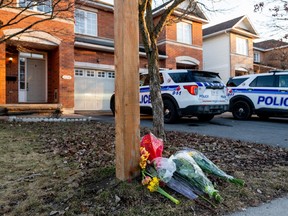 Flowers and police cars outside the Ottawa house where six people were killed, March 7, 2024.