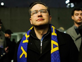 Conservative Leader Pierre Poilievre wears a scarf in the colours of the Ukrainian flag.