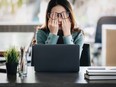 Young woman stressed working at computer