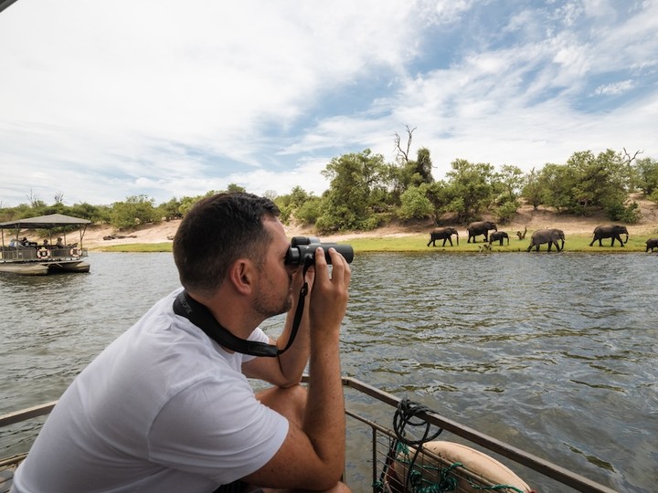  Taking in the view with the Swarovski Optik Companion binoculars while cruising the Chobe River.