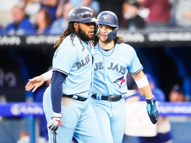 Vladdy Guerrero Jr. celebrates his two-run home run with Bo Bichette in a Sept. 14, 2023, game against the Texas Rangers in Toronto.