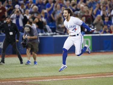 Blue Jays shortstop Bo Bichette leaps home after hitting a home run during a 2019 game against the New York Yankees in Toronto.