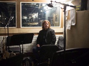 Composer Bob Hallett sits at a piano