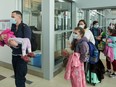 Ukrainian nationals fleeing the ongoing Russian invasion of Ukraine arrive in at the Richardson International Airport in Winnipeg on Monday, May 23, 2022.