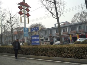 A man walks along the road in the city of Handan in northern China's Hebei province on Feb. 28, 2024