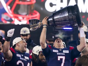 Montreal Alouettes quarterback Cody Fajardo (7) hoists the Grey Cup as fullback Alexandre Gagne (34) looks on as the Alouettes celebrate defeating the Winnipeg Blue Bombers in the 110th CFL Grey Cup in Hamilton, Ont., on Sunday, November 19, 2023. Fajardo and the Montreal Alouettes won't have the element of surprise working for them when they open the 2024 CFL season.THE CANADIAN PRESS/Frank Gunn