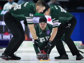 Prince Edward Island skip Tyler Smith, back centre, watches his shot as second Chris Gallant, left, and lead Ed White sweep while playing Quebec during the Brier, in Regina, on Tuesday, March 5, 2024.