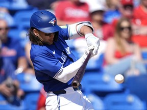 Toronto Blue Jays' Bo Bichette hits a single in the fifth inning of a spring training baseball game against the Philadelphia Phillies Monday, March 4, 2024, in Dunedin, Fla.
