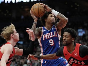 Philadelphia 76ers guard Kelly Oubre Jr. (9) drives to the hoop between Toronto Raptors guard Kobi Simmons (8) and teammate Gradey Dick (1) during second half NBA basketball action in Toronto, Sunday, March 31, 2024.
