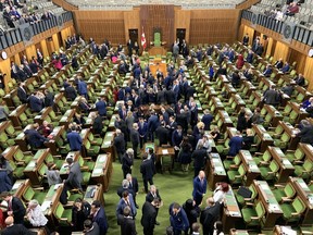 MPs are pictured inside the House of Commons.