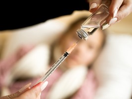 A stock image of a syringe and a child