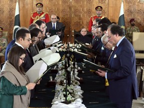 In this photo released by the Pakistan's President Office, President Asif Ali Zardari, center left, administers the oath from federal ministers as Prime Minister Shehbaz Sharif, center right, watches during a ceremony at the Presidential Palace, in Islamabad, Pakistan, Monday, March 11, 2024. The 19-member Cabinet of Pakistan's newly-elected Prime Minister Sharif was sworn in Monday during a brief ceremony. (Pakistan's President Office via AP)