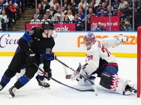 Toronto Maple Leafs forward Connor Dewar (24) scores on Washington Capitals goaltender Charlie Lindgren (79) during second period NHL hockey action in Toronto on Thursday, March 28, 2024.