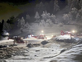 Mountain rescuers and helicopters participate in a rescue mission the Tete Blanche mountain in the Swiss alps mountains, near Sion, Switzerland, Sunday, March 10, 2024. Five cross-country skiers have been found dead after going missing over the weekend near Switzerland's famed Matterhorn, Swiss police said Monday. Rescue authorities announced a search in difficult weather conditions Sunday for six skiers missing. The group set off Saturday on a route between the resort town of Zermatt, at the foot of the Matterhorn, and the village of Arolla, near the border with Italy. (Valais cantonal police via AP)