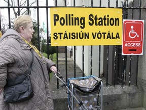 A woman arrives to vote in a referendum on the proposed changes to the wording of the Constitution relating to the areas of family and care are seen at Treasa Naofa on Donore Avenue, Dublin , in Dublin, Ireland, Friday, March 8, 2024. As the world marks International Women's Day, in Ireland, voters are deciding on Friday whether to change the constitution to remove passages referring to women's domestic duties and broadening the definition of the family.