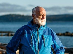 Eric Peterson standing for a portrait next to the ocean