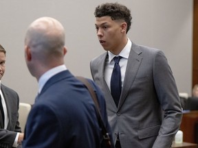 FILE - Jackson Mahomes, right, leaves the courtroom following a bond motion hearing in Johnson County District Court, May 16, 2023, in Olathe, Kan. The younger brother of Super Bowl-winning Kansas City Chiefs quarterback Patrick Mahomes has been sentenced to six months' probation in a case alleging an assault on a woman. Jackson Mahomes, 23, appeared Thursday, March 7, 2024, for his sentencing hearing via video conference and pleaded guilty to a single misdemeanor count of battery, according to online court records.