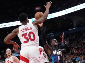 Brooklyn Nets guard Dennis Schroder (17) drives to the net past Toronto Raptors guard Ochai Agbaji (30) during second half NBA basketball action in Toronto, Monday, March 25, 2024.