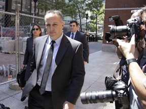 FILE - Barry Cadden, president of the New England Compounding Center, followed by members of his legal team, arrive at the federal courthouse for sentencing, June 26, 2017, in Boston. The co-founder of a specialty pharmacy that was at the center of a deadly national meningitis outbreak in 2012 pleaded no contest to involuntary manslaughter in Michigan, authorities said Tuesday, March 5, 2024.