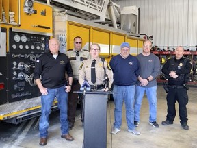 In this image made from video provided by Illinois State Police Troop 6, Illinois State Police Capt. Jody Huffman, at podium, speaks during a news conference about the five people, including three children, who were killed Monday, March 11, 2024, after a school bus and semitruck collided on a highway in western Illinois. (Illinois State Police Troop 6 via AP)