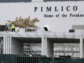 FILE - A crew works on putting up a platform near the main entrance at Pimlico Race Course, May 15, 2020, in Baltimore. A new plan, released Thursday, March 14, 2024, to rebuild Baltimore's storied but deteriorating Pimlico Race Course and transfer the track to state control is making a late charge down the stretch of Maryland's legislative session.