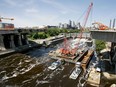 FILE - A section of the new I-35 bridge is raised from a barge in the foaming Mississippi River at Minneapolis, June 24, 2008. The I-35W bridge was rebuilt in less than 14 months. Experts say the rebuilding of Baltimore's Francis Scott Key Bridge likely will take longer, with estimates ranging from 18 months to several years.
