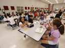 FILE - Students at Madison Crossing Elementary School in Canton, Miss., eat lunch in the school's cafeteria on Friday, Aug. 9, 2019. Student nutrition programs and advocates say the provincial government needs to double the budget allocated to Ontario student nutrition programs ahead of the tabling of the spring budget on March 26.
