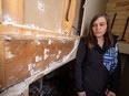 Michele Siebold looks at the bullet-riddled wall where her common-law spouse, Patrick Kimmel, was shot dead by police after a 30-hour standoff at their Penbrooke Meadows home on March 15.