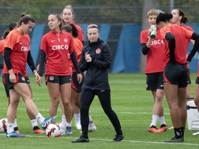 Defending champion Canada learns its path in Paris this summer as the Olympic football tournament draw is held in suburban Saint-Denis. Canada coach Bev Priestman, centre, runs a training session in Montreal, Thursday, Oct. 26, 2023.