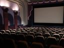 A new study from Canada's independent cinema owners says their industry is in crisis and many theatres need increased public funding to stay afloat. A man waits for the film 'Back to the Future' to begin, at Caprice Cinemas, in Surrey, B.C., on Sunday, June 28, 2020.