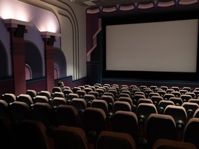 A new study from Canada's independent cinema owners says their industry is in crisis and many theatres need increased public funding to stay afloat. A man waits for the film 'Back to the Future' to begin, at Caprice Cinemas, in Surrey, B.C., on Sunday, June 28, 2020.