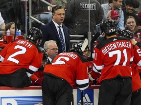 New Jersey Devils interim coach Travis Green watches players during a huddle in the third period of the team's NHL hockey game against the St. Louis Blues on Thursday, March 7, 2024, in Newark, N.J.
