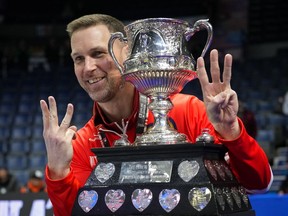 Canada skip Brad Gushue holds up six fingers to represent his sixth championship as he poses with the Brier Tankard after defeating Saskatchewan in the final at the Brier, in Regina, Sunday, March 10, 2024. Gushue is approaching this year's men's world curling championships like it could be his last.THE CANADIAN PRESS/Darryl Dyck