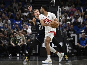 Toronto Raptors centre Jontay Porter, right, is defended by Orlando Magic centre Moritz Wagner (21) during the first half of an NBA basketball game, Sunday, March 17, 2024, in Orlando, Fla. Toronto police say they are not investigating Raptors backup centre Jontay Porter.
