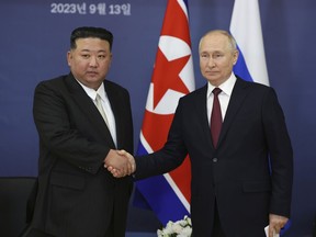 FILE - Russian President Vladimir Putin, right, and North Korean leader Kim Jong Un shake hands during their meeting at the Vostochny cosmodrome outside the city of Tsiolkovsky, about 200 kilometers (125 miles) from the city of Blagoveshchensk in the far eastern Amur region, Russia on Sept. 13, 2023. North Korea has shipped around 7,000 containers filled with munitions and other military equipment to Russia since 2023 to help support its war in Ukraine, South Korea's defense minister said Monday, March 18, 2024.