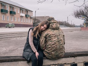 Elvira sits in Makiv with boyfriend Oleksii