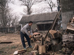 man chops wood