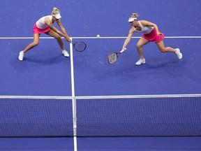 Gabriela Dabrowski, of Canada, right, returns a shot alongside doubles partner Erin Routliffe, of New Zealand, left, during the women's doubles final of the U.S. Open tennis championships against Laura Siegemund, of Germany, and Vera Zvonareva, of Russia, Sunday, Sept. 10, 2023, in New York.