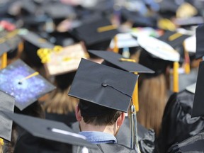 FILE - Graduates at the University of Toledo commencement ceremony in Toledo, Ohio, May 5, 2018. Another 78,000 Americans are getting their federal student loans canceled through a program that helps teachers, nurses, firefighters and other public servants, the Biden administration announced Thursday. The Education Department is canceling the borrowers' loans because they reached 10 years of payments while working in public service, making them eligible for relief under the Public Service Loan Forgiveness program.