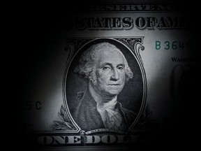 FILE - The likeness of George Washington is seen on a U.S. one dollar bill, March 13, 2023, in Marple Township, Pa. The nonpartisan Congressional Budget Office says it expects the federal government will be awash in debt over the next 30 years.