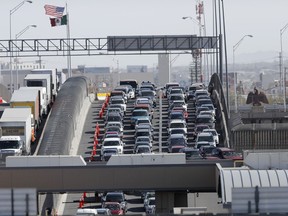 FILE - Cars and trucks line up to enter the U.S. from Mexico at a border crossing in El Paso, Texas, March 29, 2019. Most Americans think the U.S. has been significantly changed by immigrants over the past five years and while many agree immigrants contribute to the economy, there are broad concerns that even legal immigration brings risks as well, according to a new poll from The Associated Press-NORC Center for Public Affairs Research, conducted March 21-25, 2024.